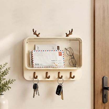 Antler key holder with transparent storage box mounted by front door, holding mail, glasses, and keys in entryway